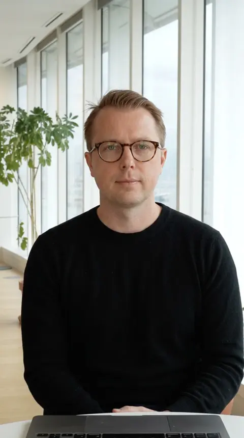 Paul's twin at a laptop by the window